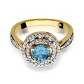 Złoty pierścionek ozdobiony diamentami i topazem 0,80 ct
